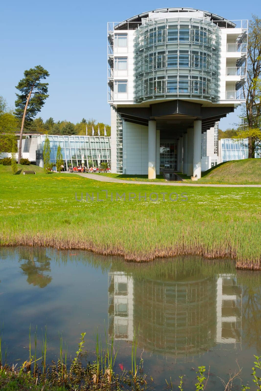 Hotel wing is reflected in a pool