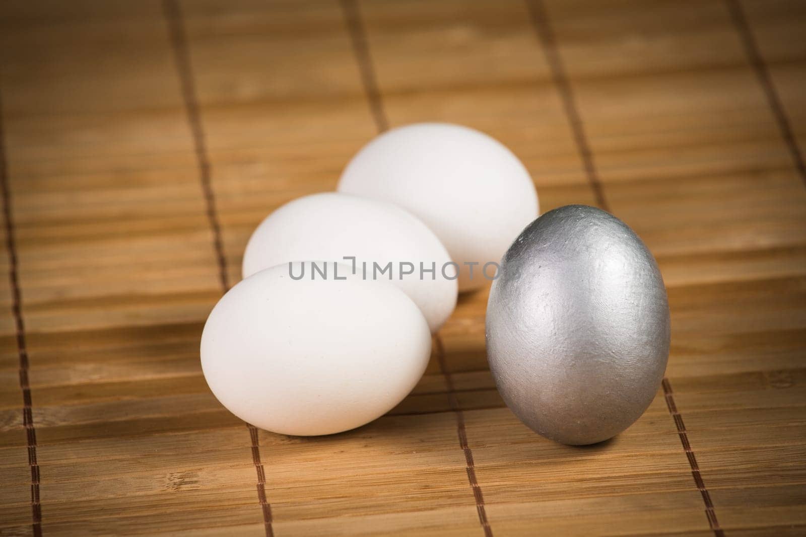 Silver and white Easter eggs with wood background