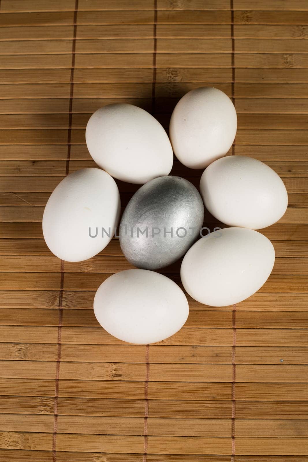 Silver and white Easter eggs with wood background