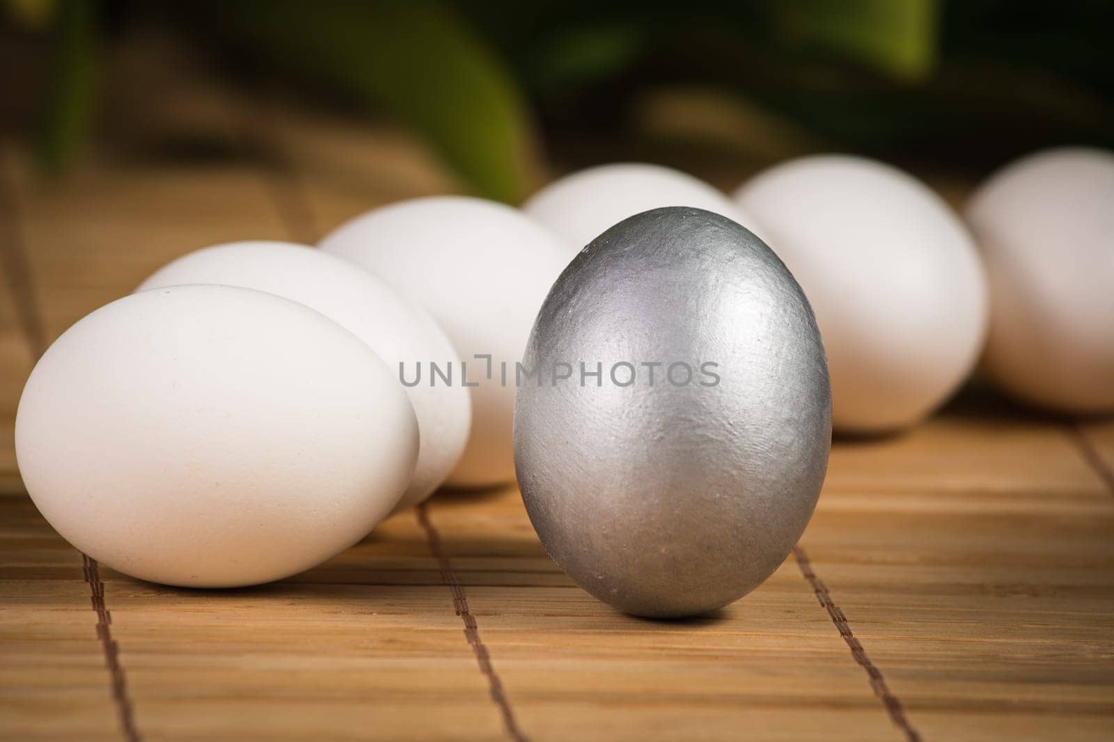 Silver and white Easter eggs with wood background
