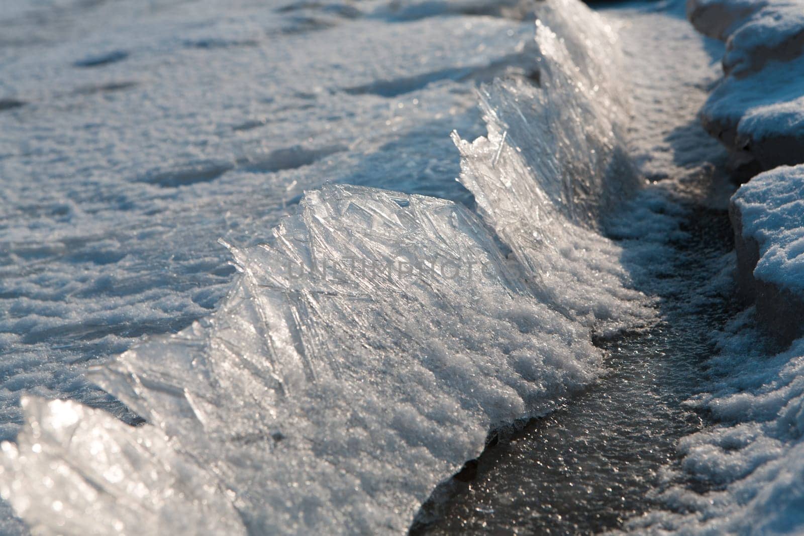Close-up of cracked ice texture on river in spring time
