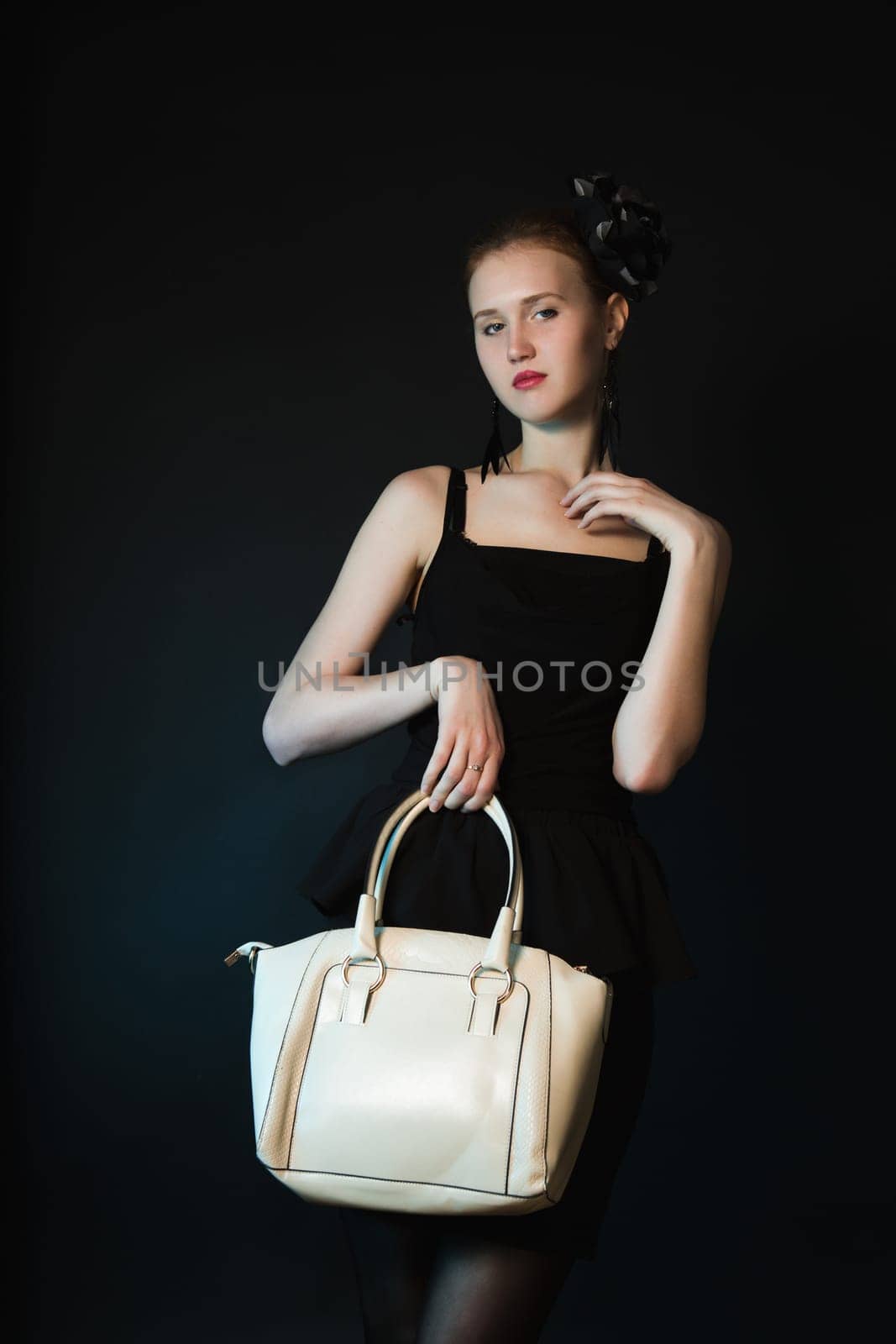 Pretty young woman with big white bag standing posing