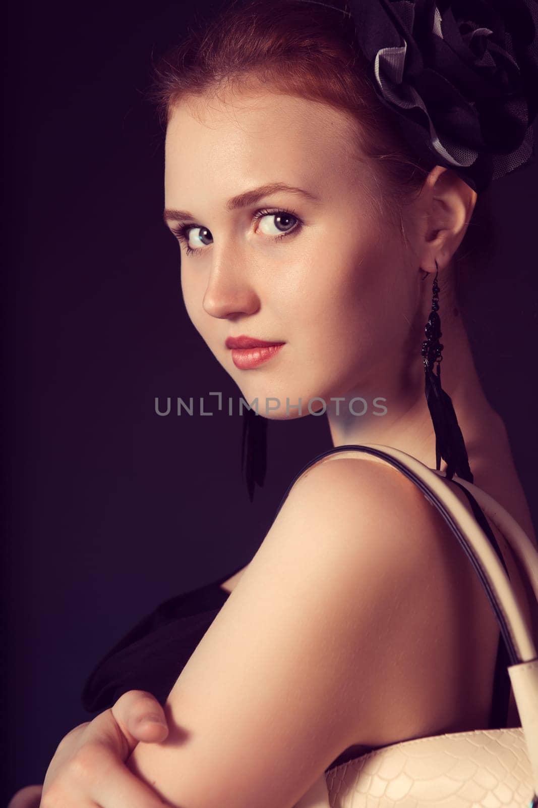 Pretty young woman with big white bag standing posing