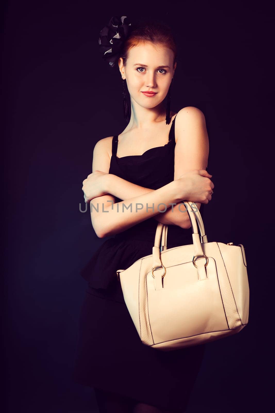 Pretty young woman with big white bag standing posing