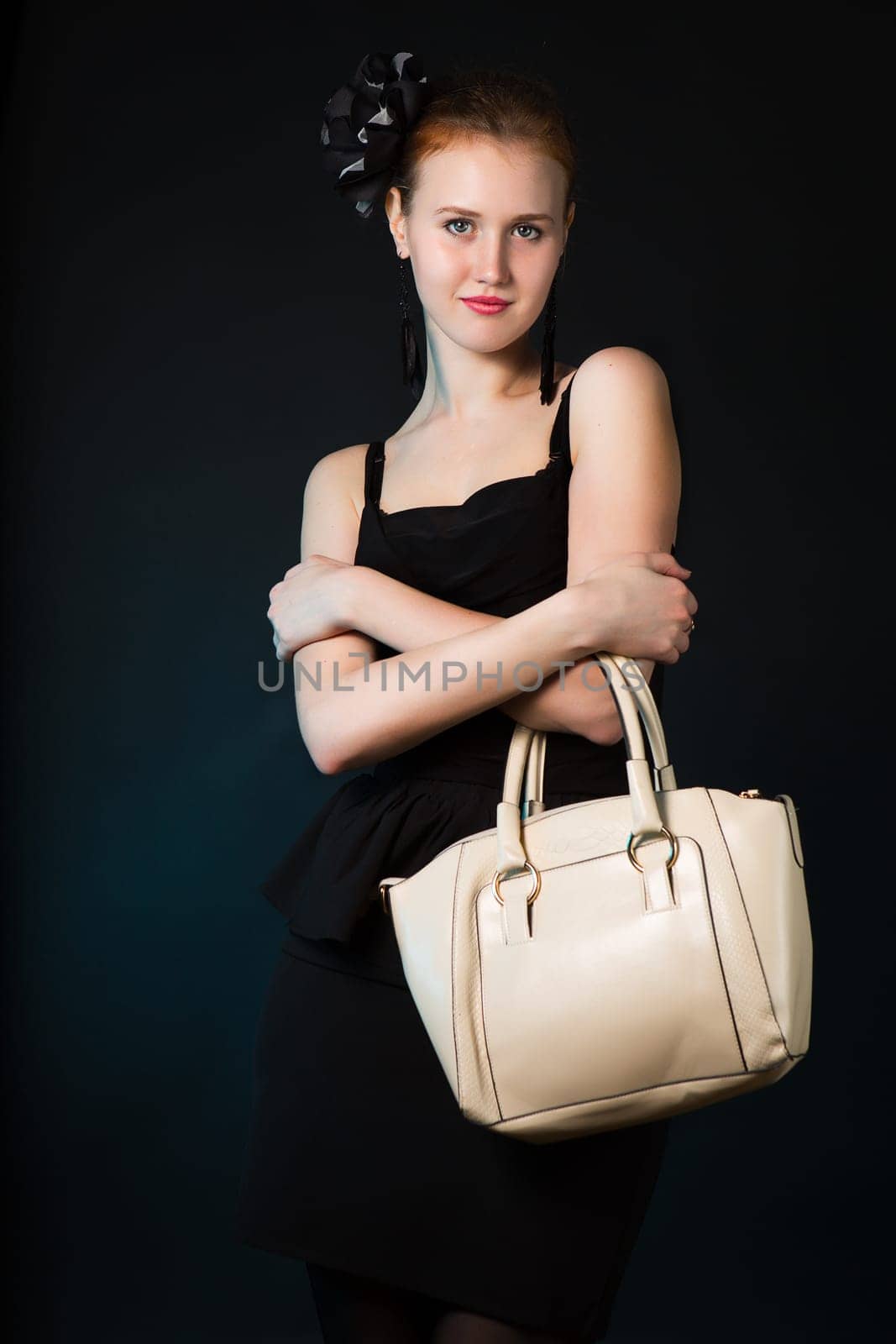 Pretty young woman with big white bag standing posing