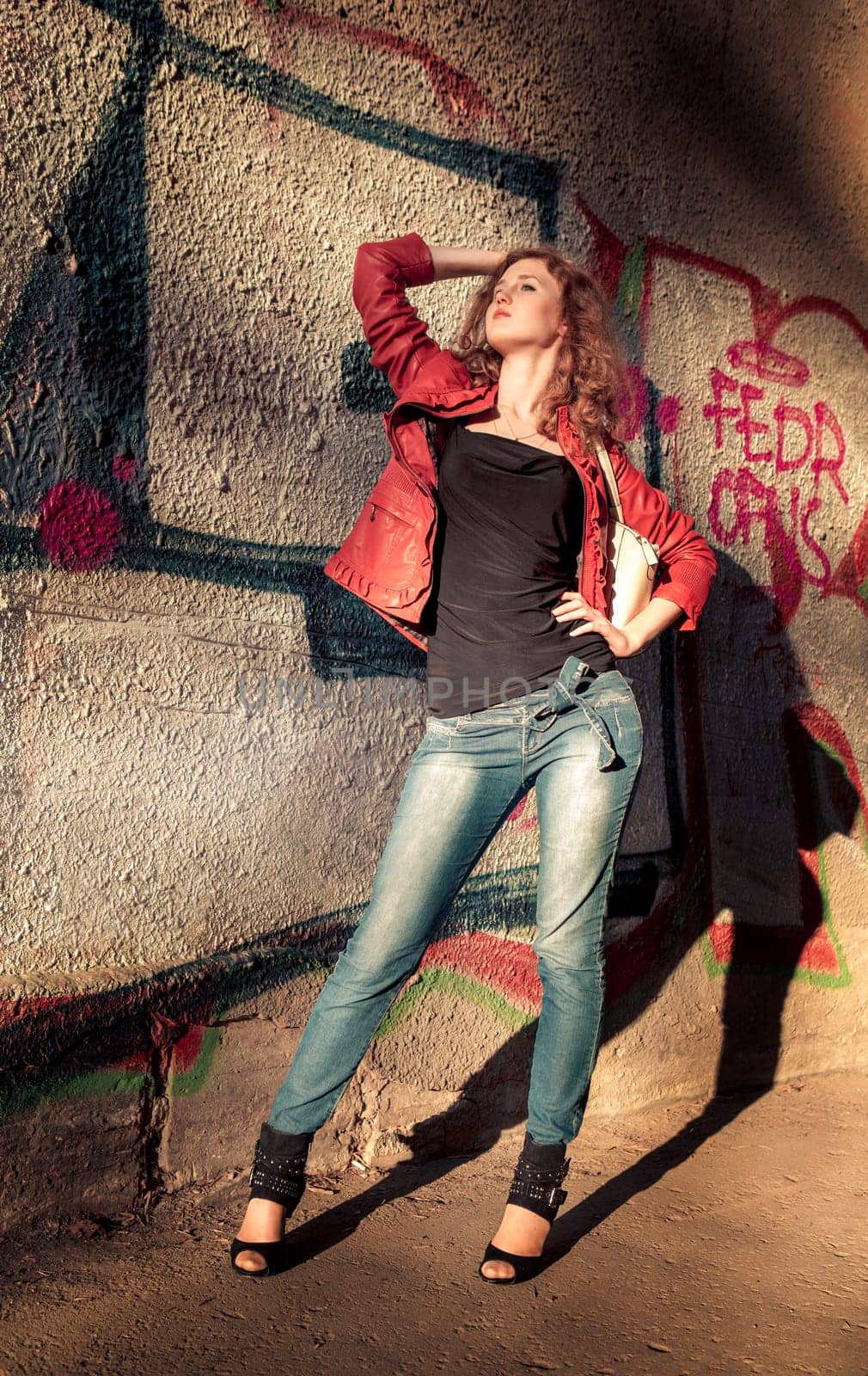 teenage girl dressed in orange jacket on the street