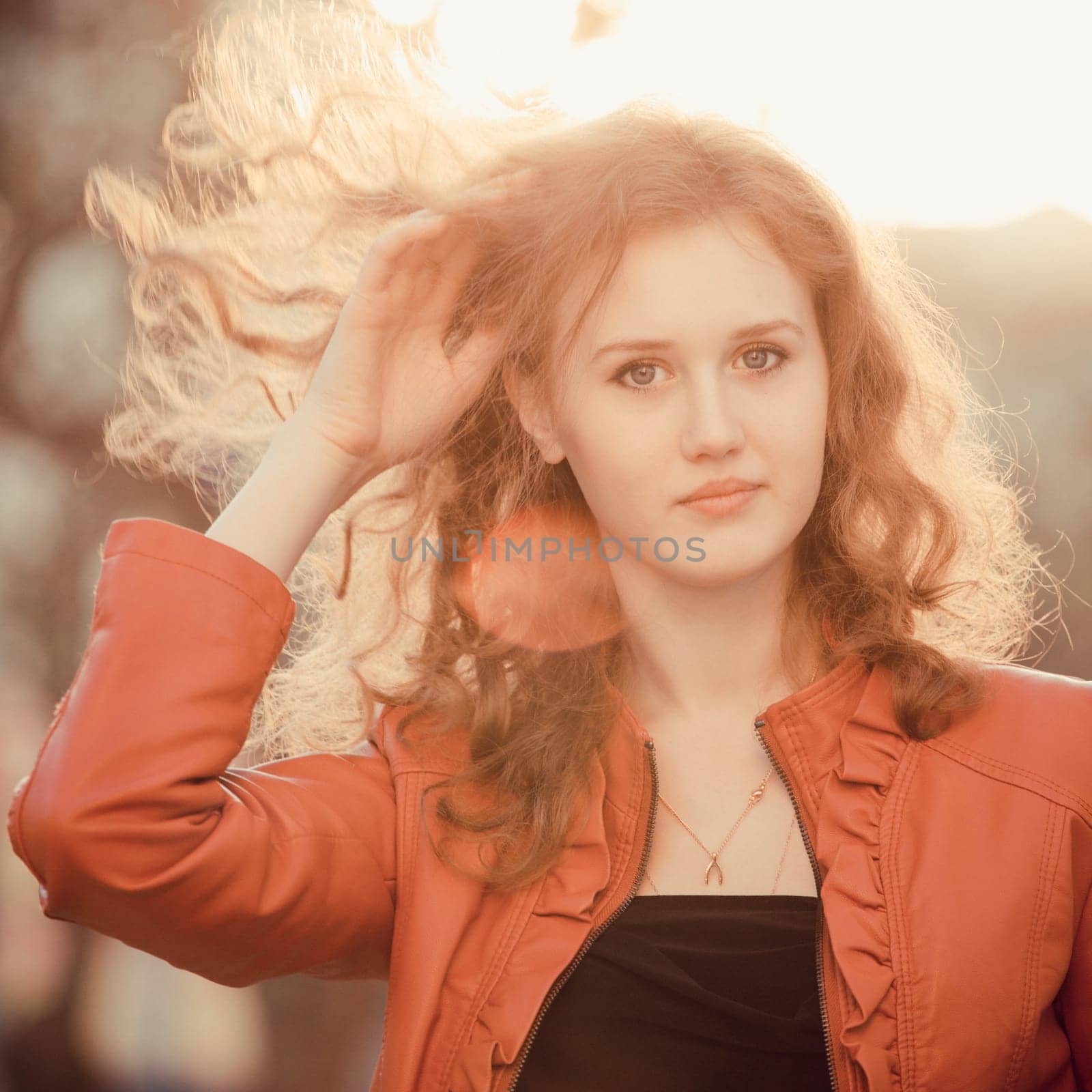 young curly Woman  smiling, on sunset