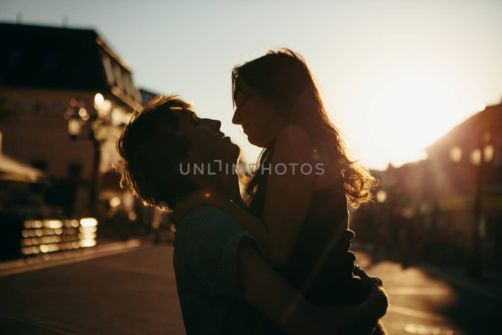 Young couple kissing over sunset
