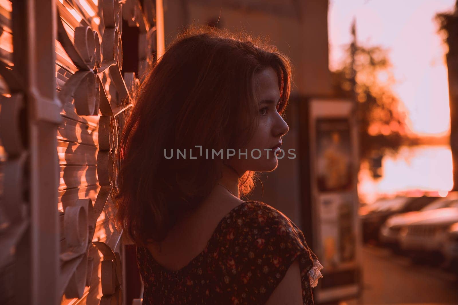 Beautiful young brunette girl sitting outdoors near the river