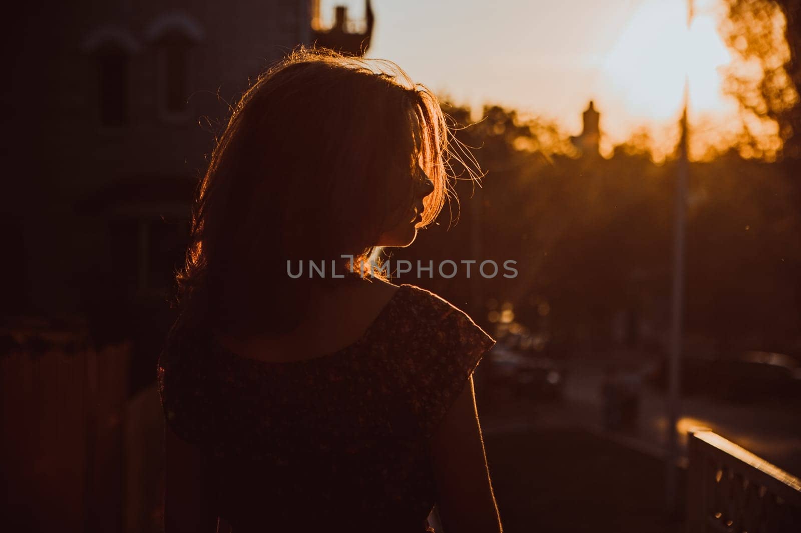 Beautiful young brunette girl sitting outdoors near the river