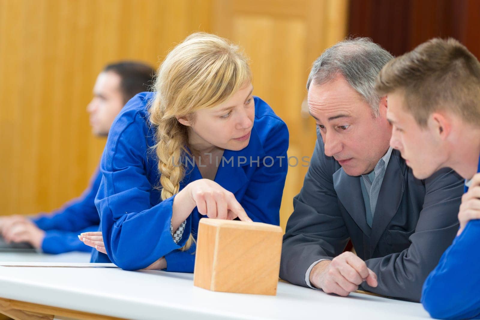 female student asking question in woodwork class
