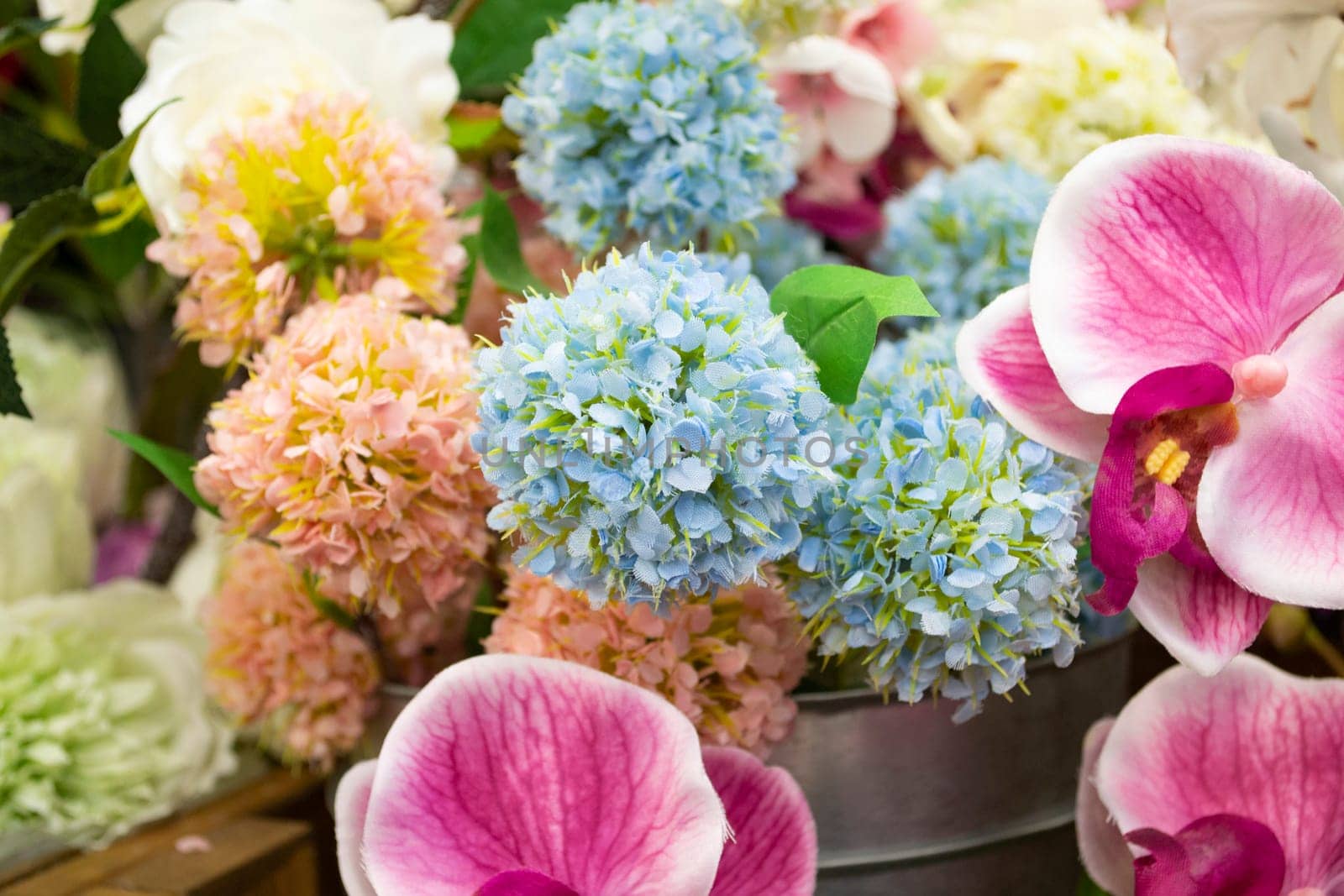 Colorful vintage decoration artificial flower near sunlight close up
