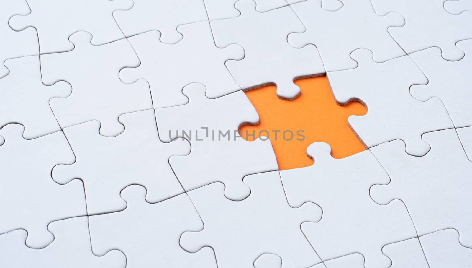 Empty white jigsaw puzzle with missing piece
