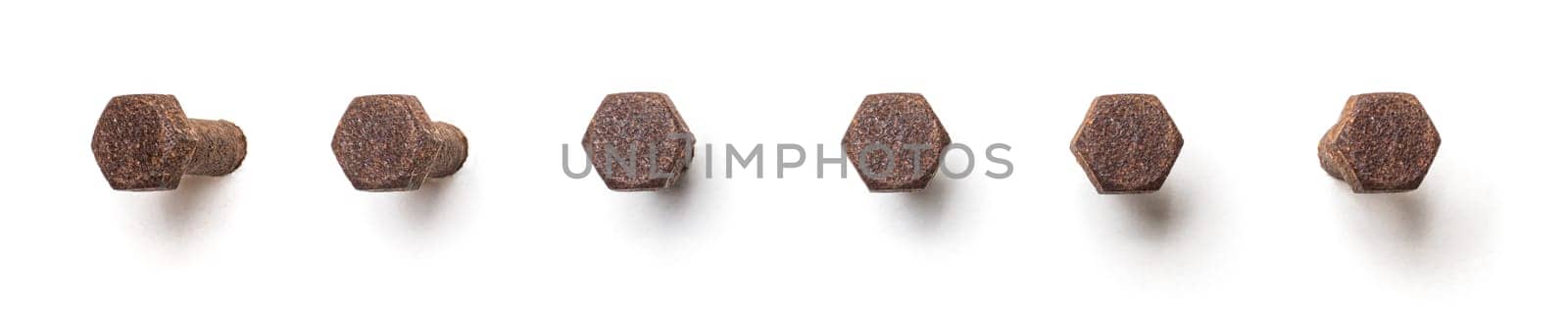 Rusty hex bolt from different perspectives on a white background