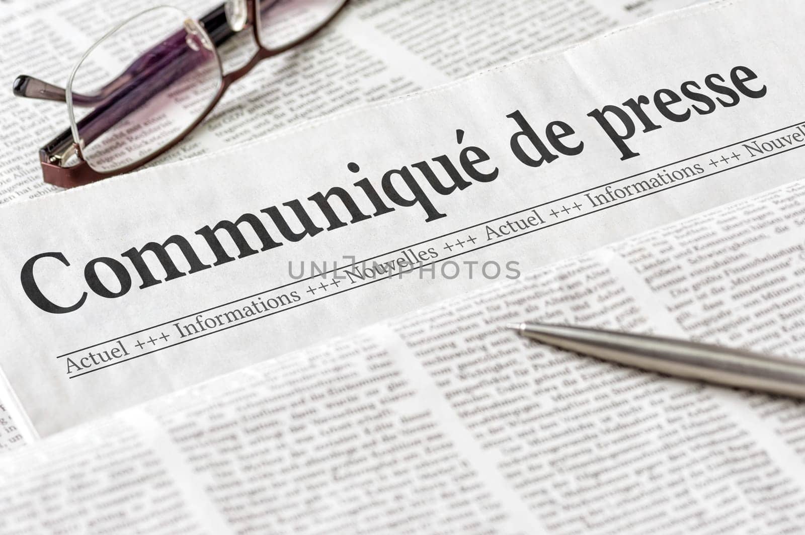 A newspaper with the headline Press Release in french - Communiqué de presse