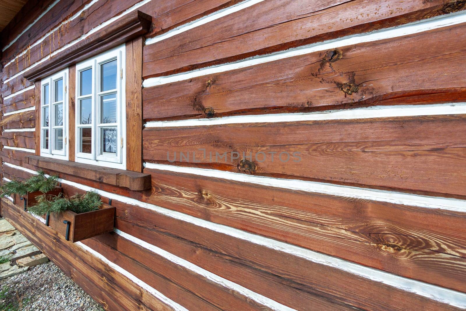 Traditional old wooden cottage in winter. High quality photo.