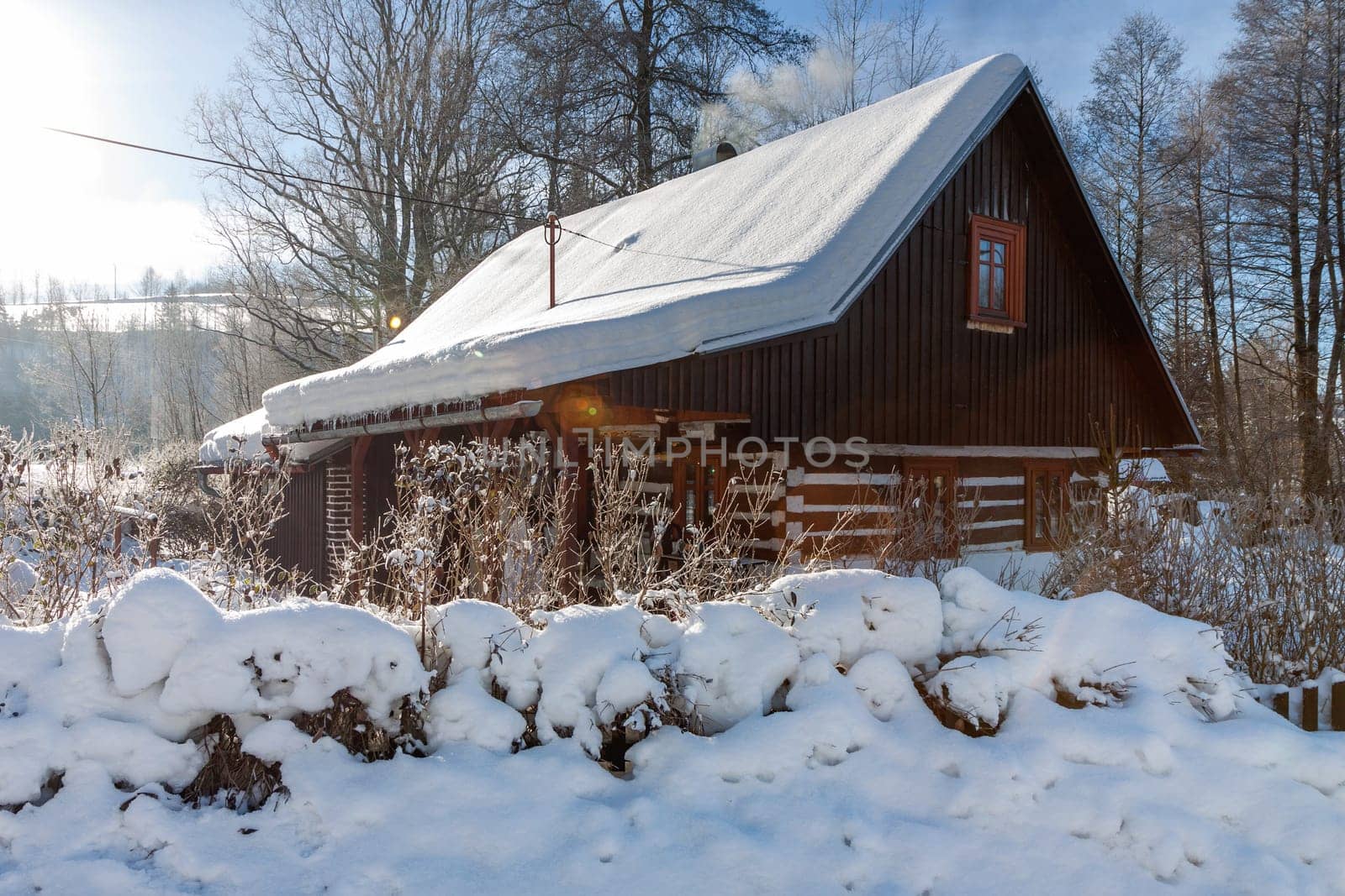 Traditional wooden cottage in winter. Czech republic