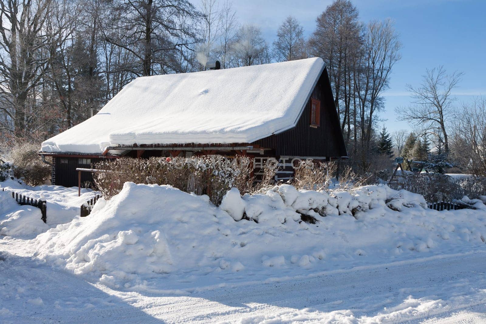 Traditional wooden cottage in winter. Czech republic