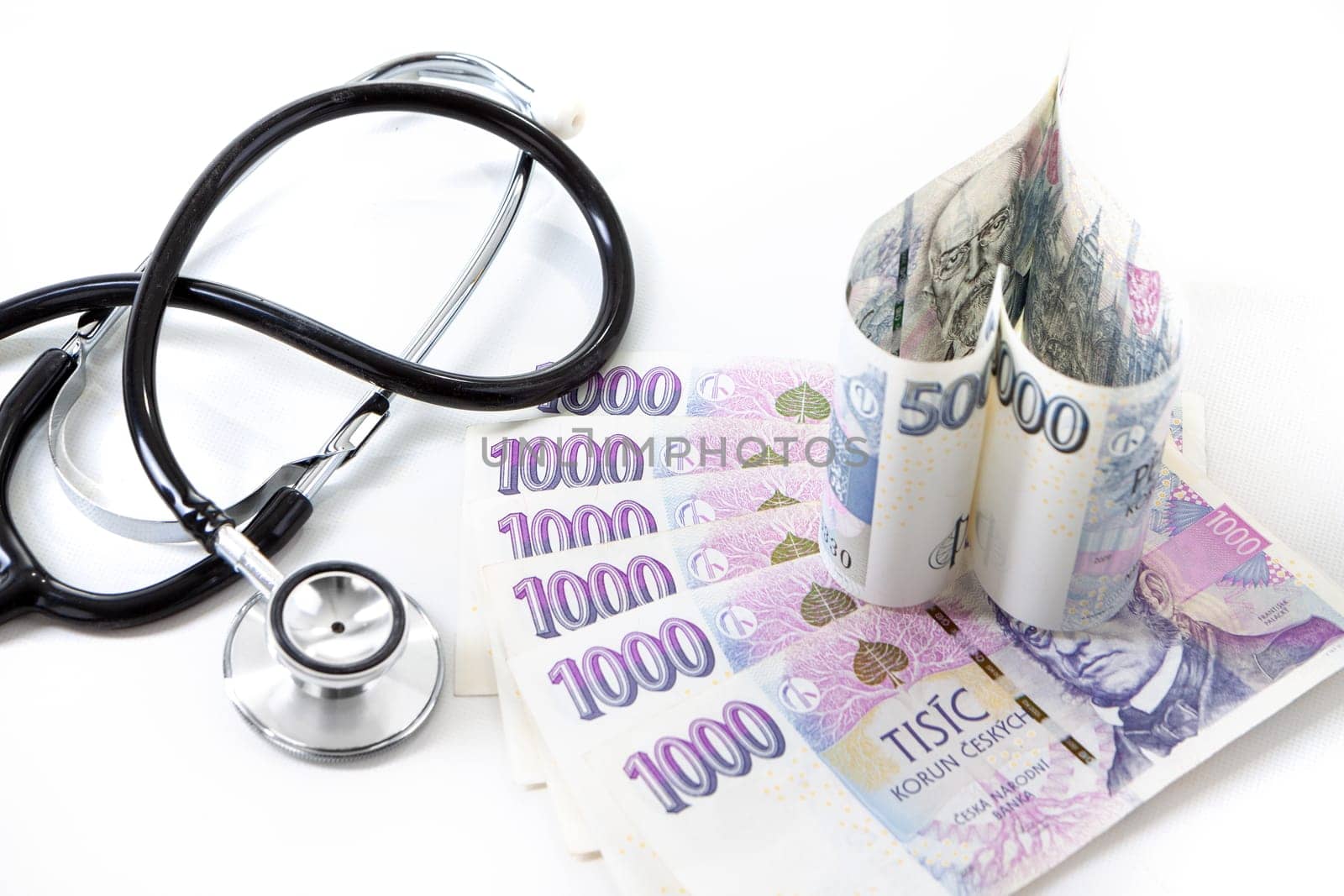 Czech paper money with heart on white background - stethoscope, heart, czech money 5000 and 1000