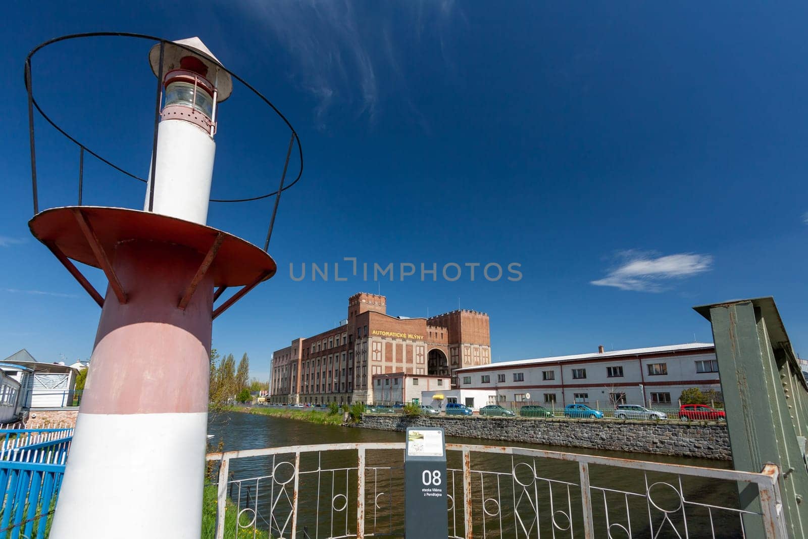 PARDUBICE, CZECH REPUBLIC - APRIL 22: Building Automatic mills Pardubice on April 22, 2016. An important monument of industrial architecture from 1910 by architect Josef Gocar. River Chrudimka with lighthouse.