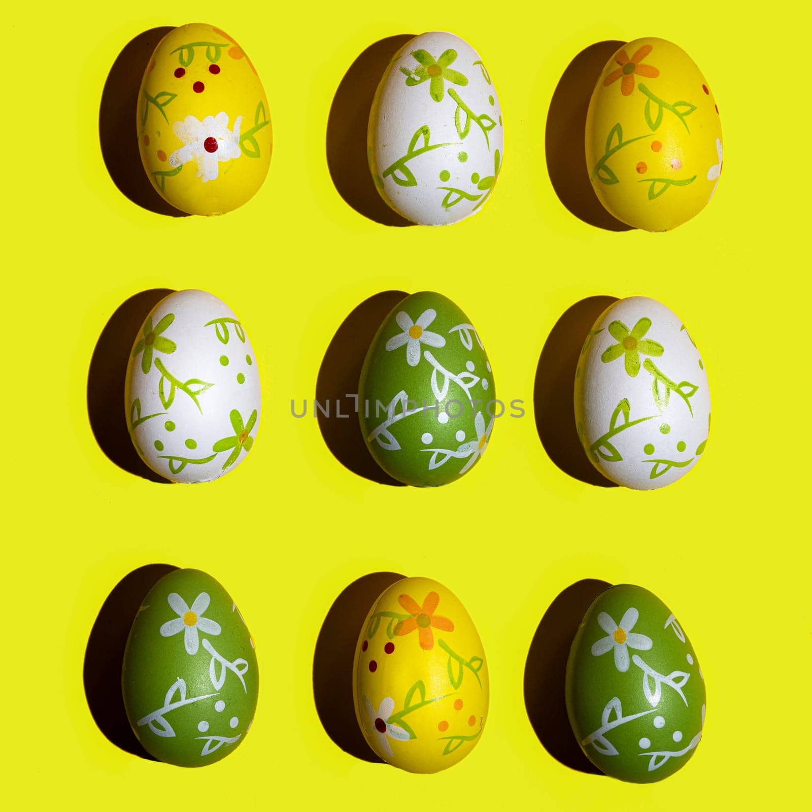 Some decorated Easter eggs on a yellow surface
