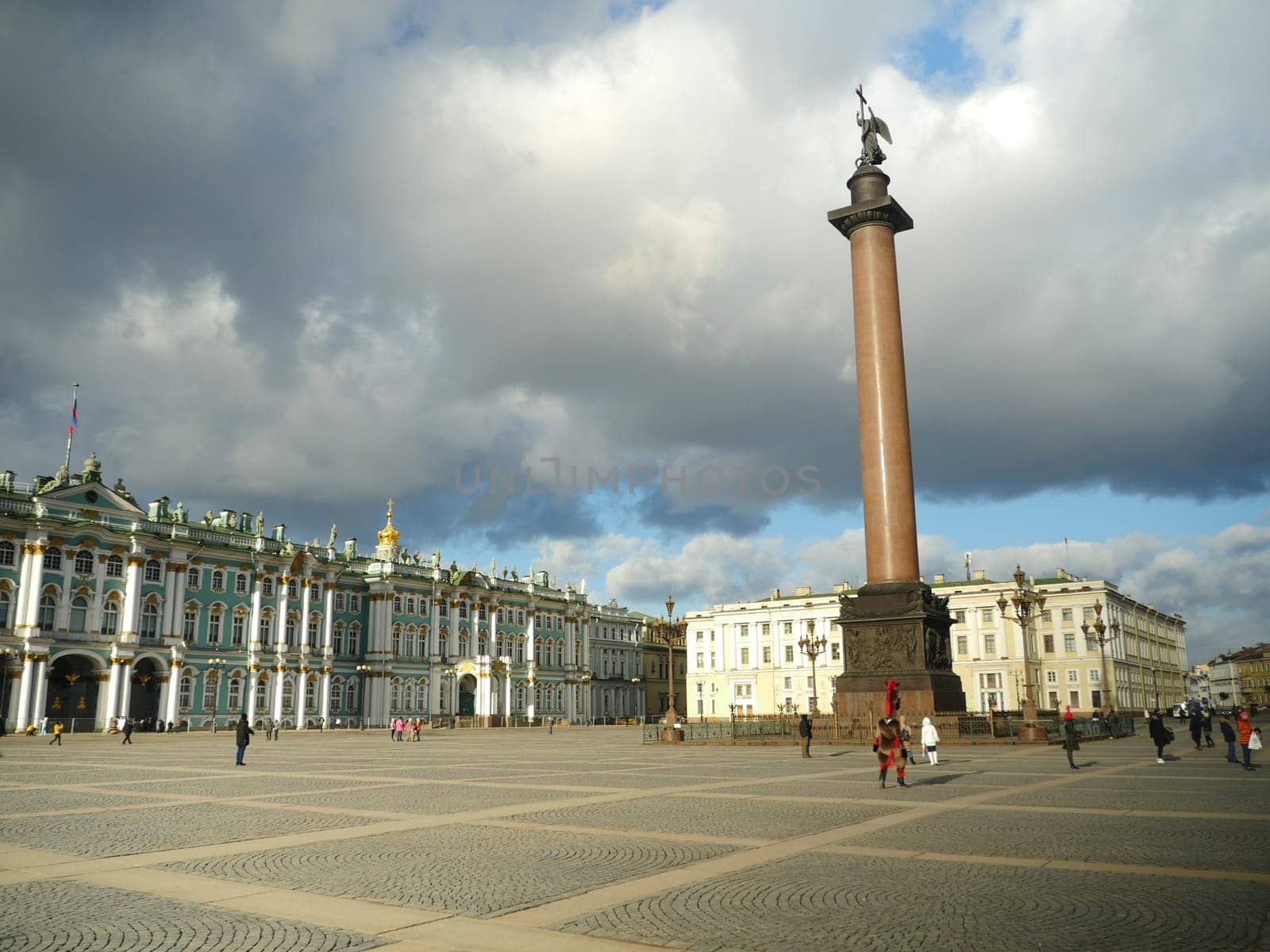 St. Petersburg, Russia, January 29, 2020. low heavy clouds over the Palace Square, the Winter Palace and the Alexander Column, tourists walk see the sights