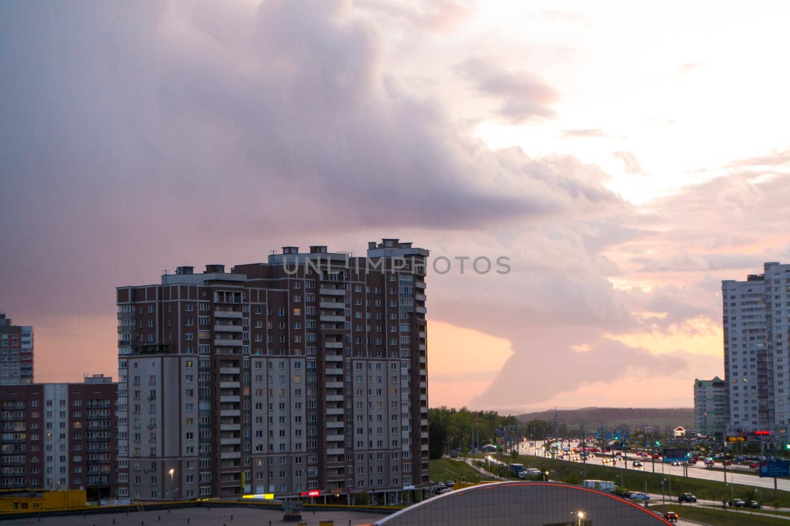 Arcus cloud or shelf cloud of a massive storm rolling over town, evening