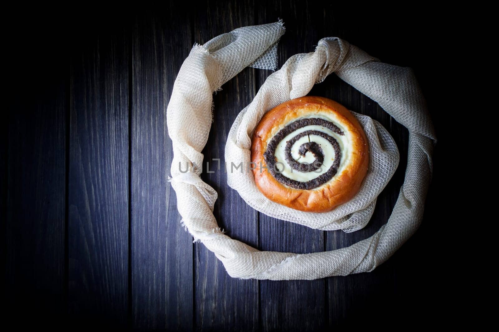 Traditional russian baking: round buns with cottage cheese vatrushka on dark background top view
