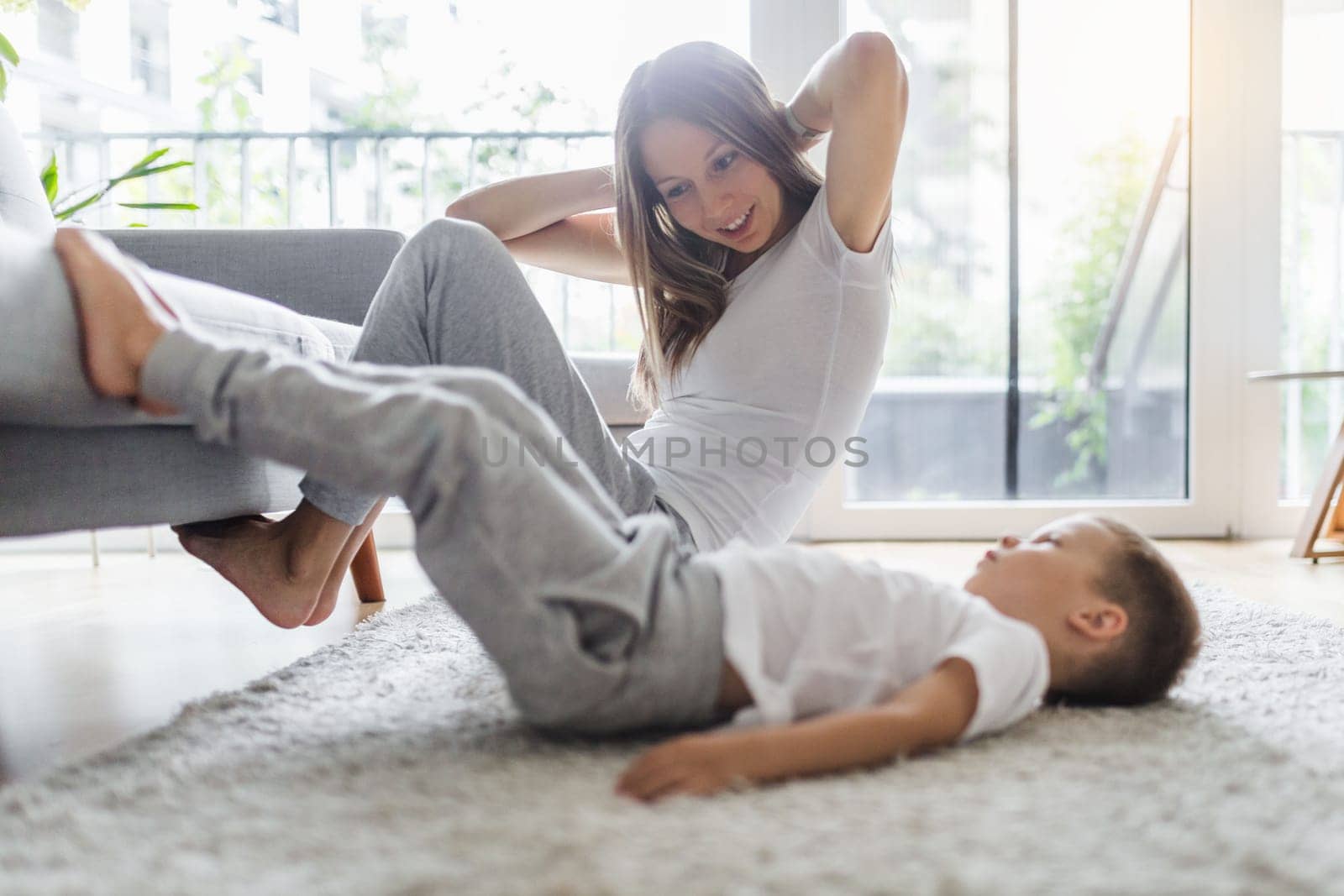 Mom with her young son working out in the living room