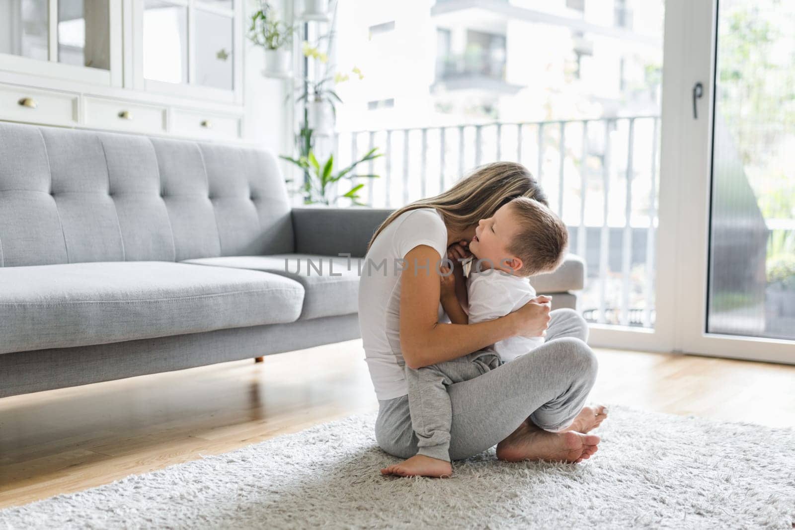Mother with her son playing in their living room