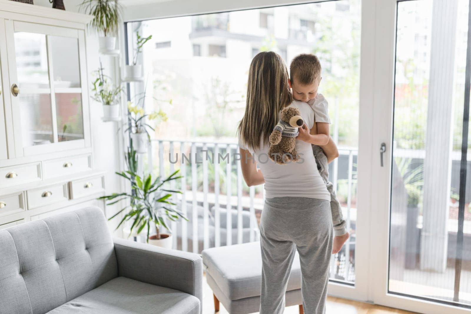 Mother with her son playing in their living room