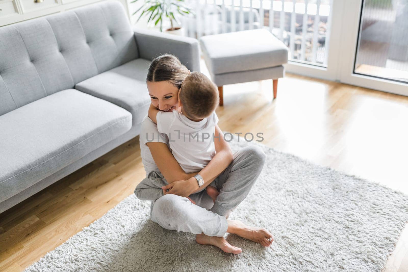 Mother with her son playing in their living room