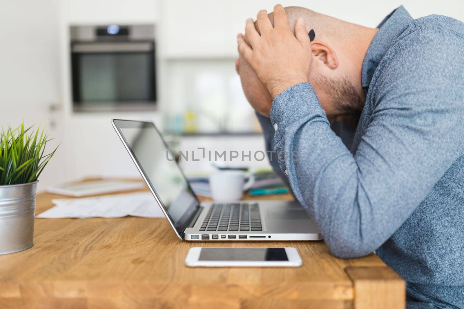 Unhappy man working from his home during the pandemic