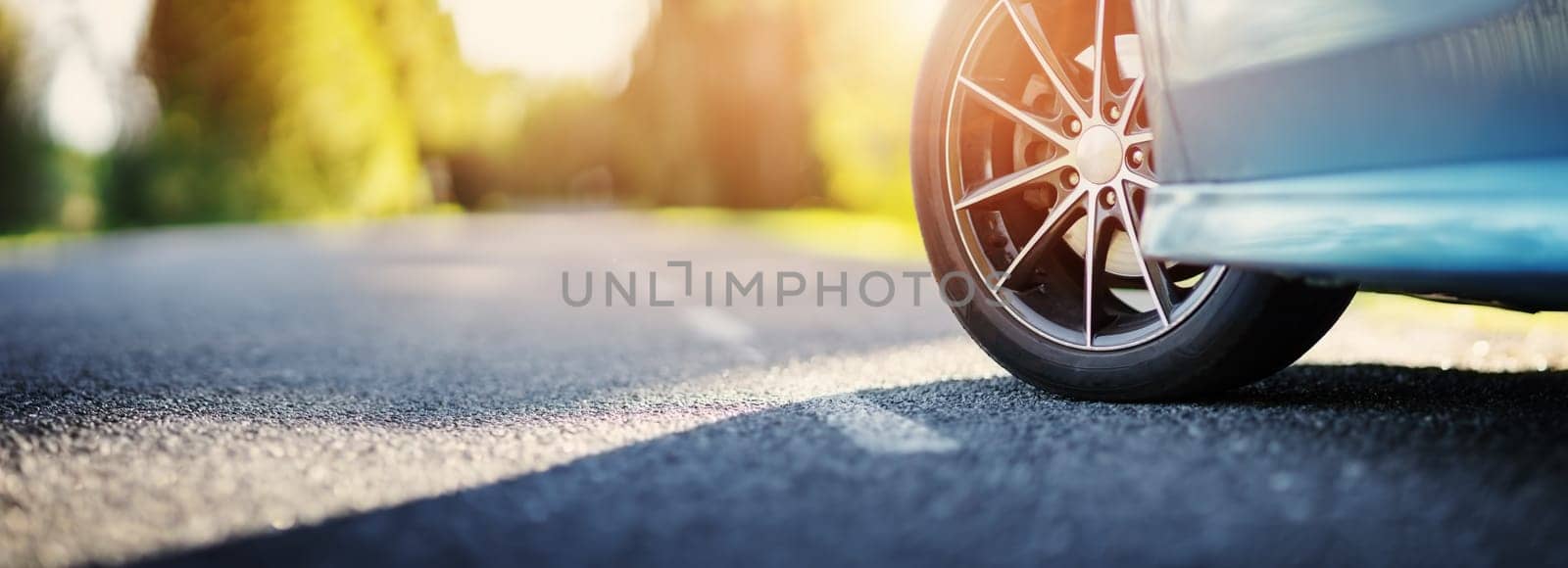 Blue car on asphalt road in summer. Concept of family vacation, trip and travel.