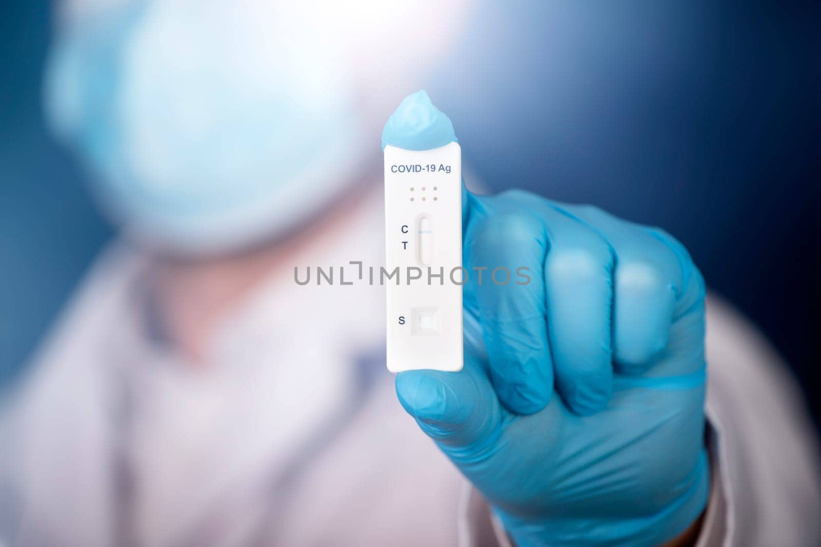 Doctor holding a test kit for viral disease COVID-19. Lab card kit tested NEGATIVE for viral novel coronavirus sars-cov-2 virus.