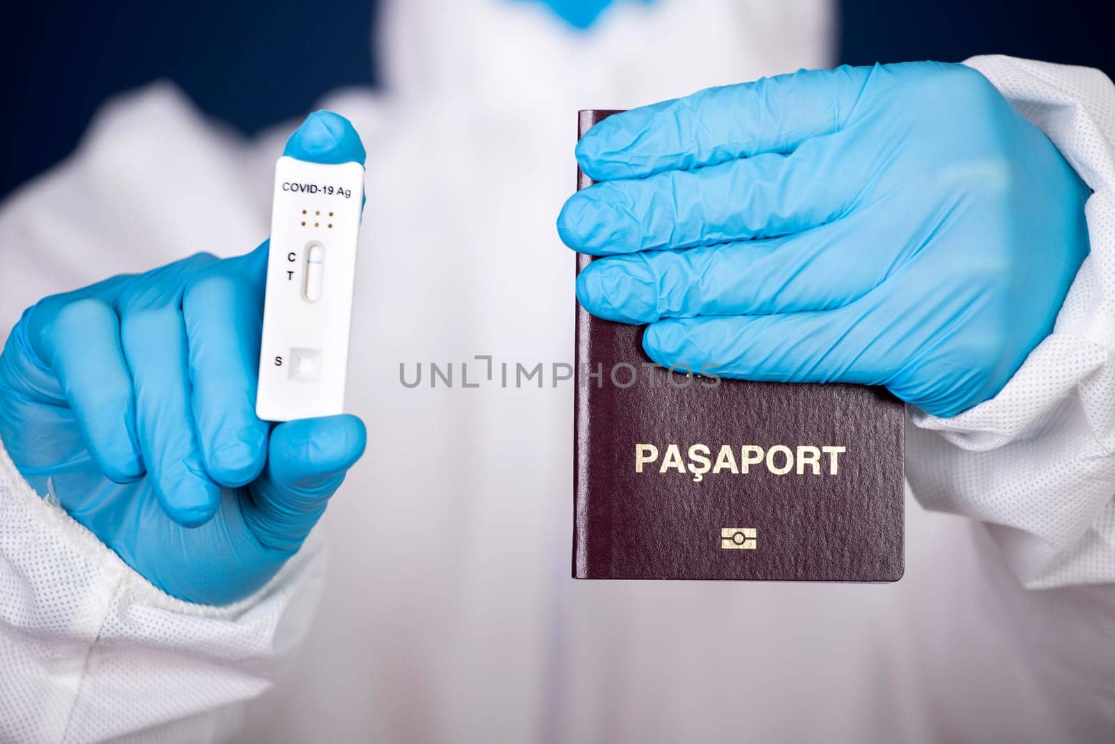 Doctor holding passport and negative covid-19 ( rapid antigen SARS-CoV-2 Ag ) test. Coronavirus and safety travel concept.