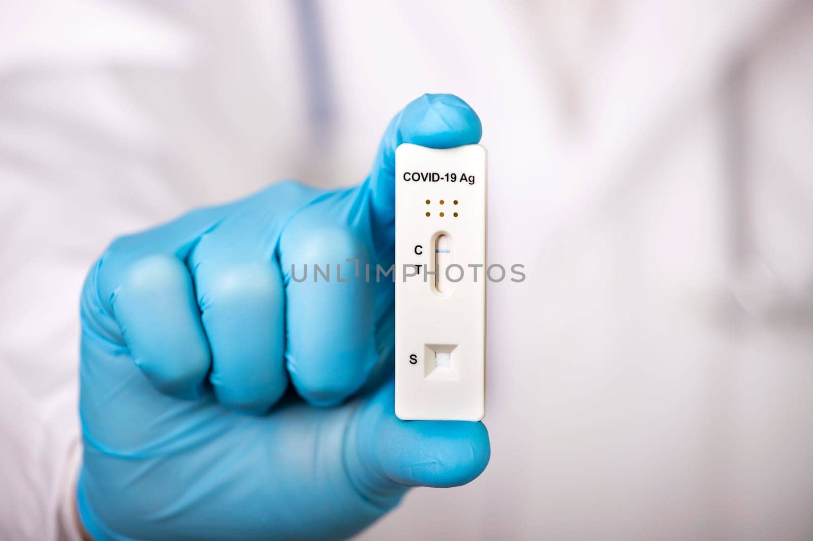 Doctor holding a test kit for viral disease COVID-19. Lab card kit tested NEGATIVE for viral novel coronavirus sars-cov-2 virus.