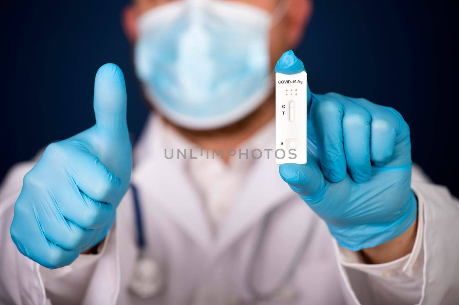 Doctor holding a test kit for viral disease COVID-19. Lab card kit tested NEGATIVE for viral novel coronavirus sars-cov-2 virus.