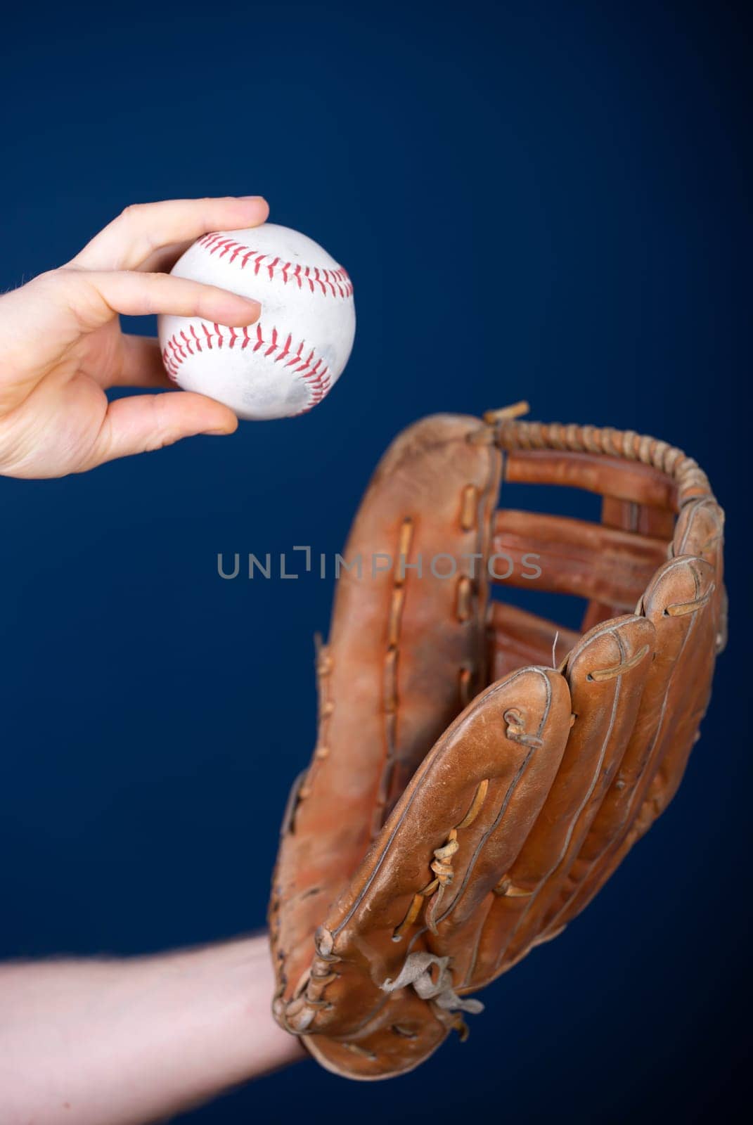 Close up image of an old used baseball and baseball glove.