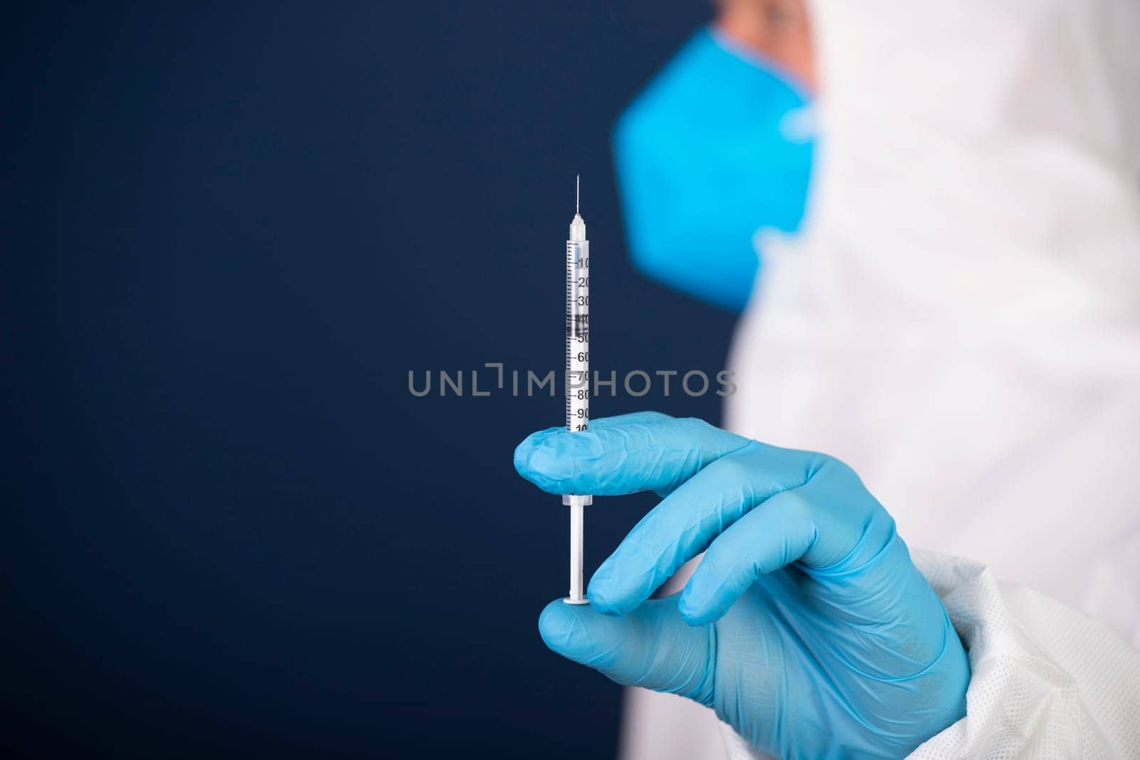 Concept of herd immunity, virus spreading in society. Doctor with syringe is preparing for vaccine.