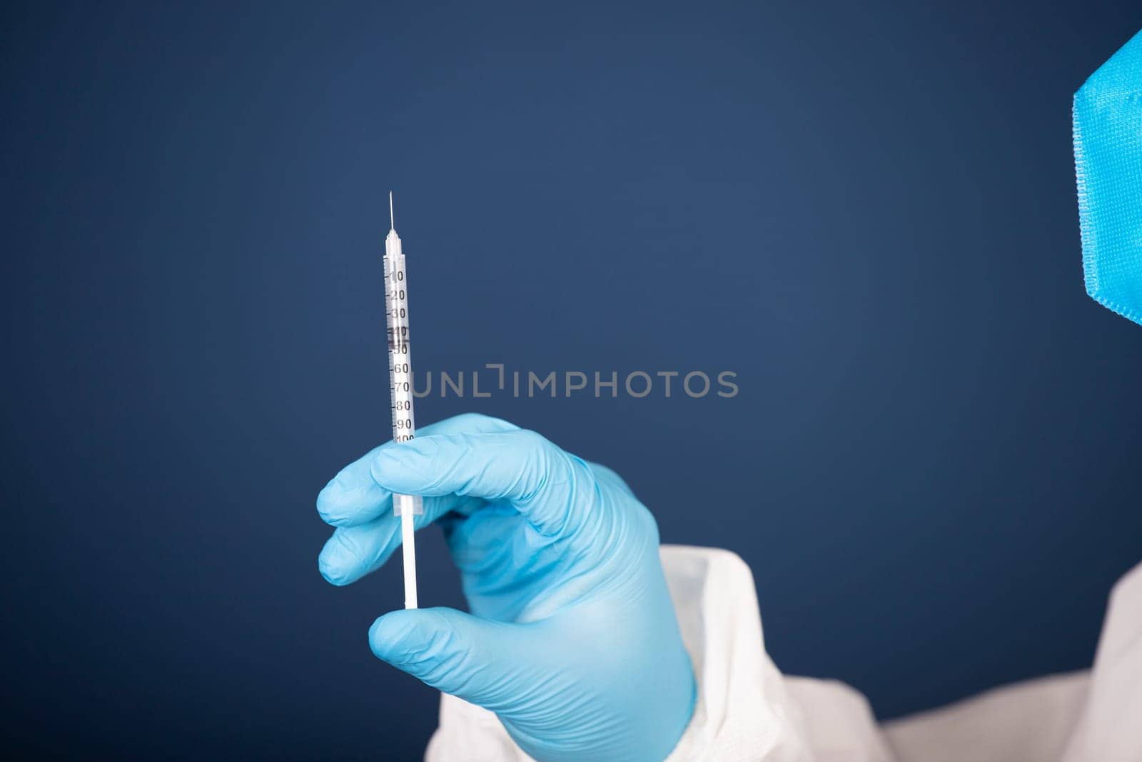 Concept of herd immunity, virus spreading in society. Doctor with syringe is preparing for vaccine.