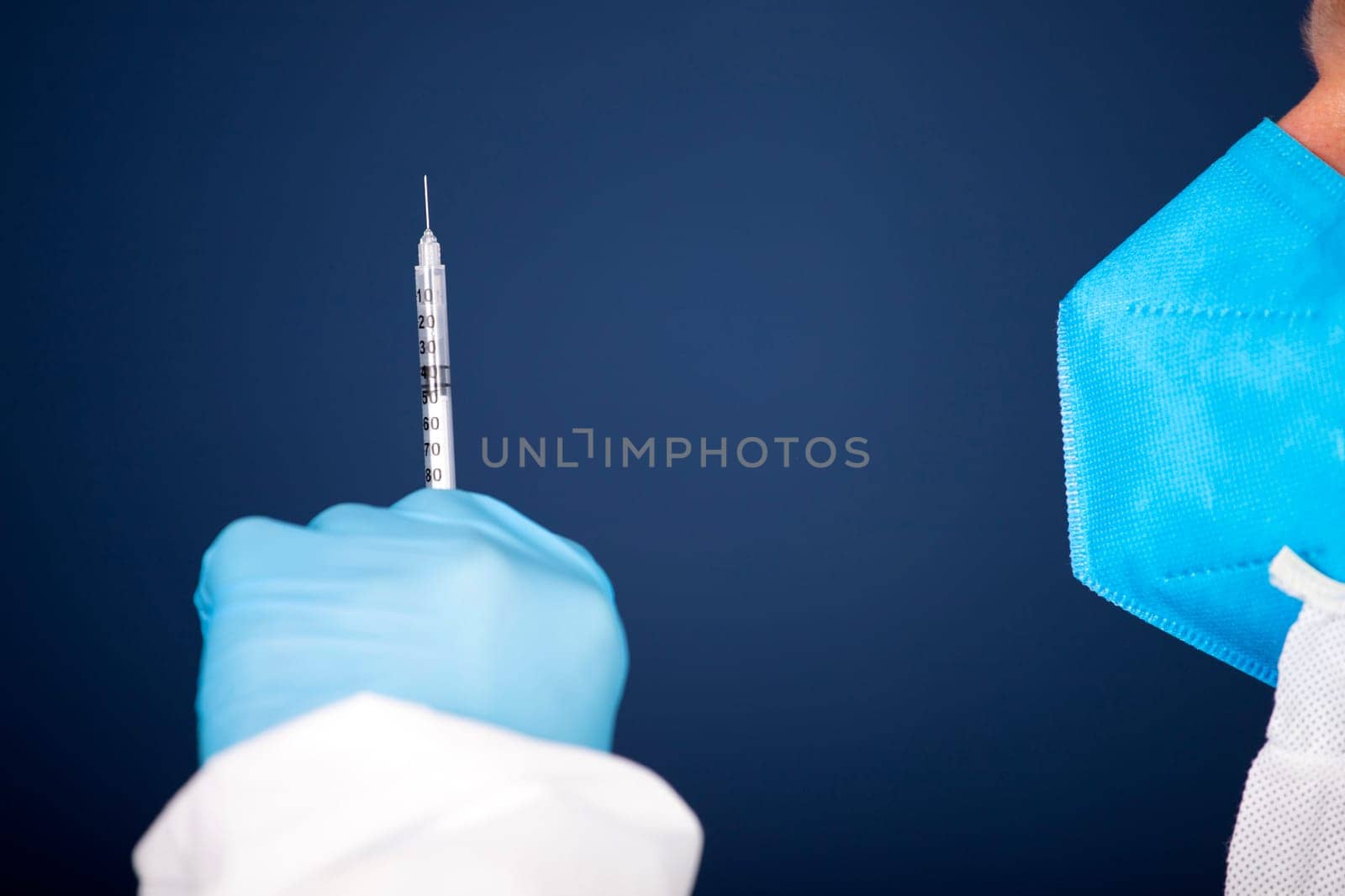 Concept of herd immunity, virus spreading in society. Doctor with syringe is preparing for vaccine.