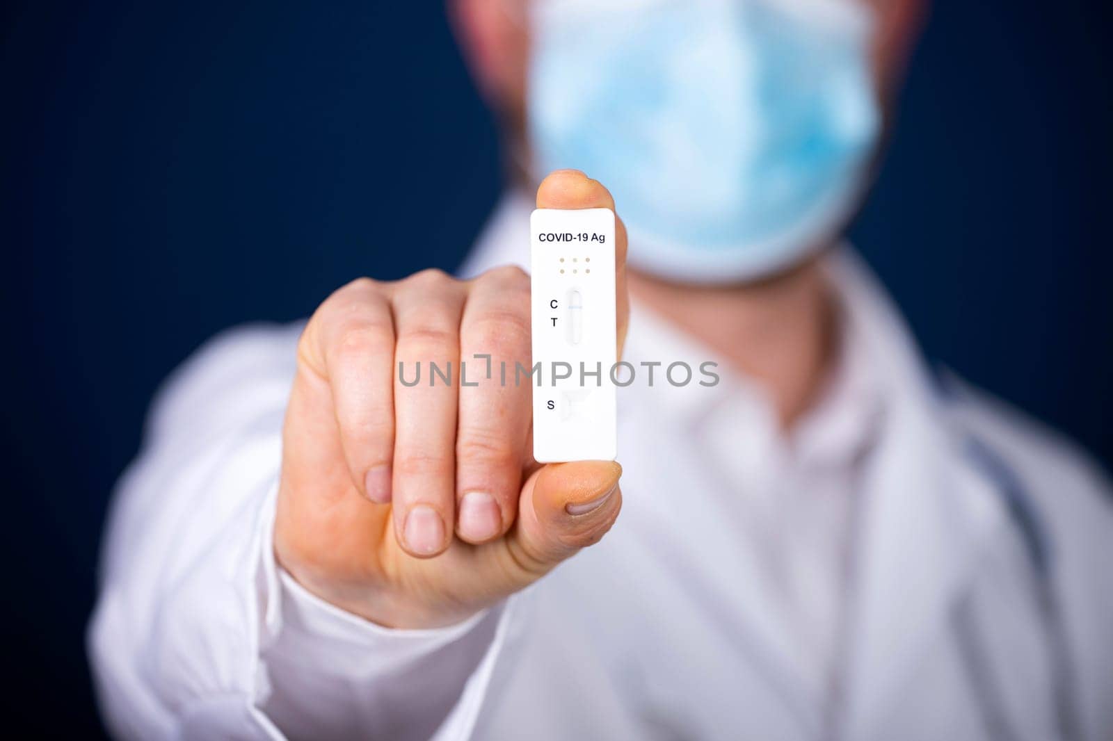 Doctor holding a test kit for viral disease COVID-19. Lab card kit tested NEGATIVE for viral novel coronavirus sars-cov-2 virus.