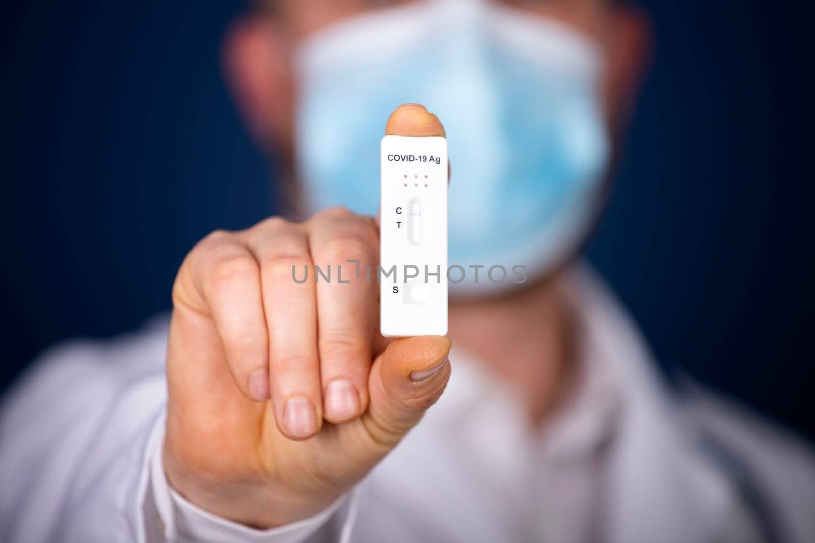 Doctor holding a test kit for viral disease COVID-19. Lab card kit tested NEGATIVE for viral novel coronavirus sars-cov-2 virus.