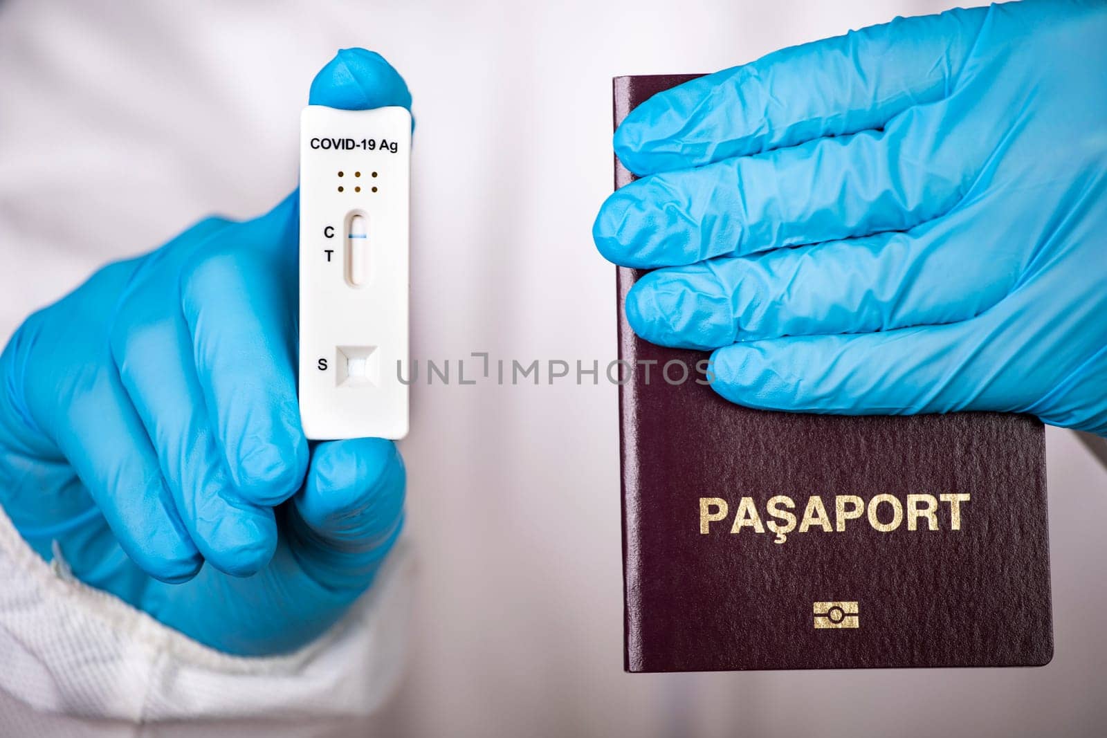 Doctor holding passport and negative covid-19 ( rapid antigen SARS-CoV-2 Ag ) test. Coronavirus and safety travel concept.