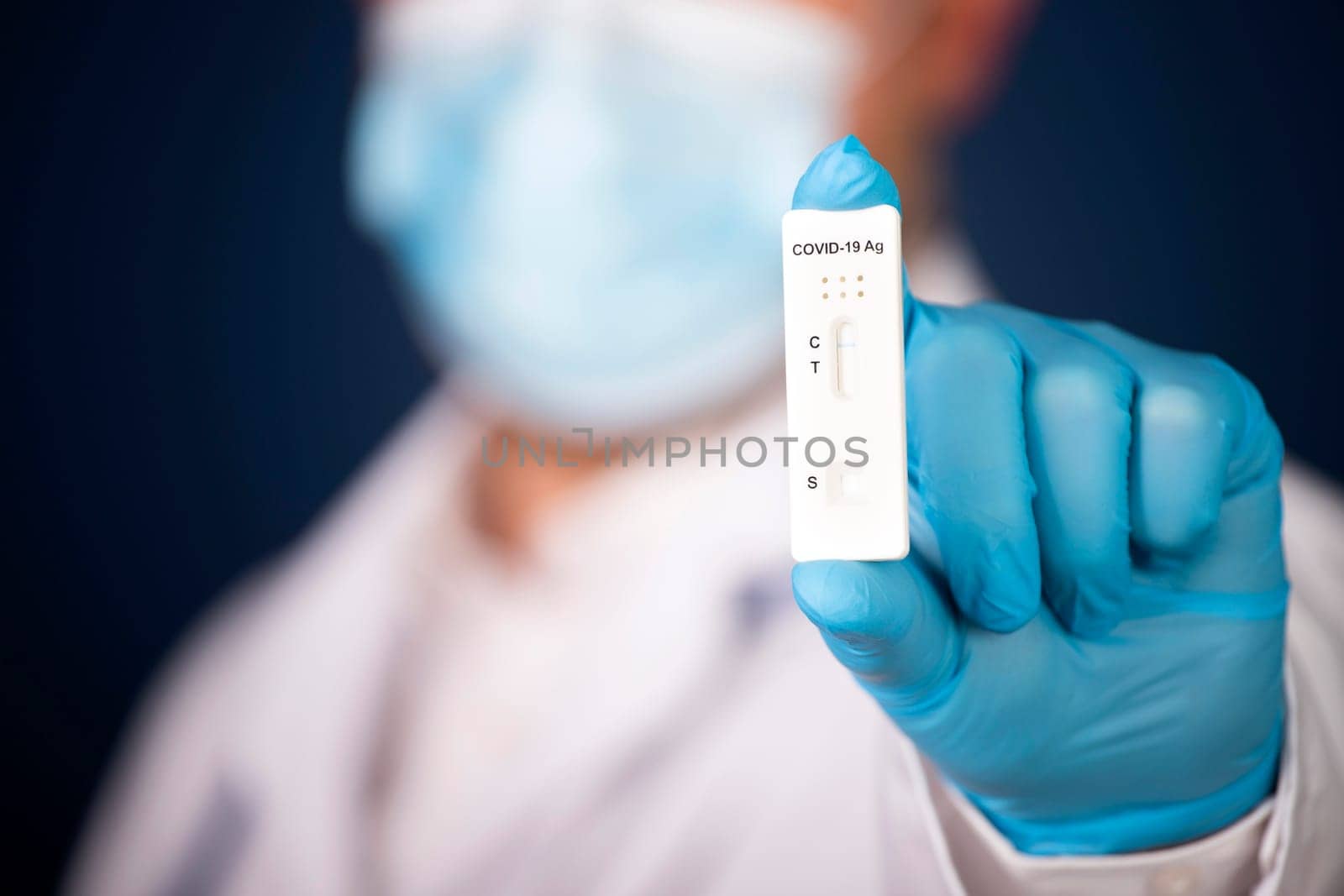 Doctor holding a test kit for viral disease COVID-19. Lab card kit tested NEGATIVE for viral novel coronavirus sars-cov-2 virus.