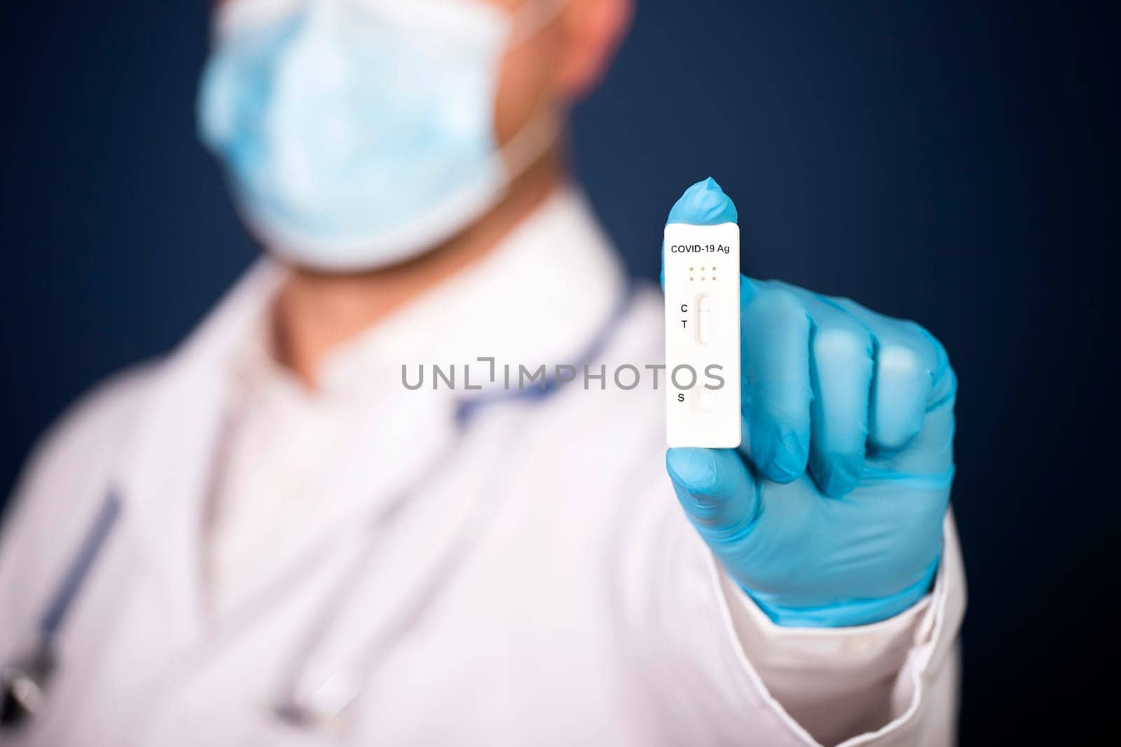 Doctor holding a test kit for viral disease COVID-19. Lab card kit tested NEGATIVE for viral novel coronavirus sars-cov-2 virus.