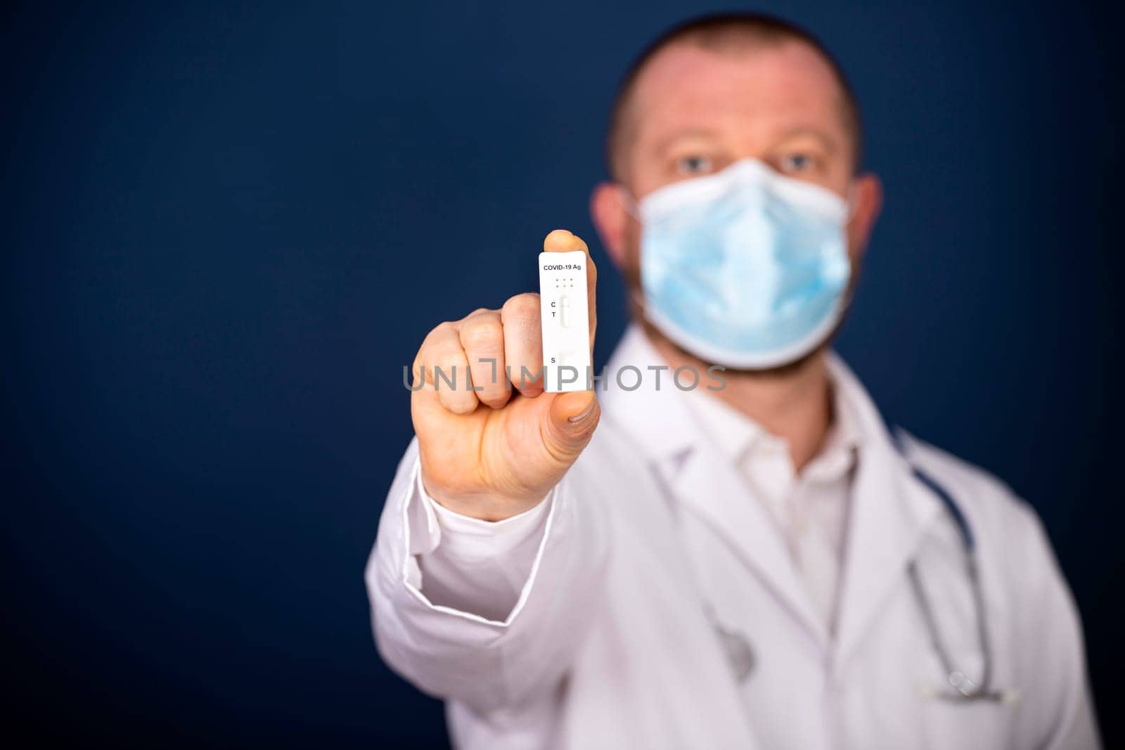 Doctor holding a test kit for viral disease COVID-19. Lab card kit tested NEGATIVE for viral novel coronavirus sars-cov-2 virus.