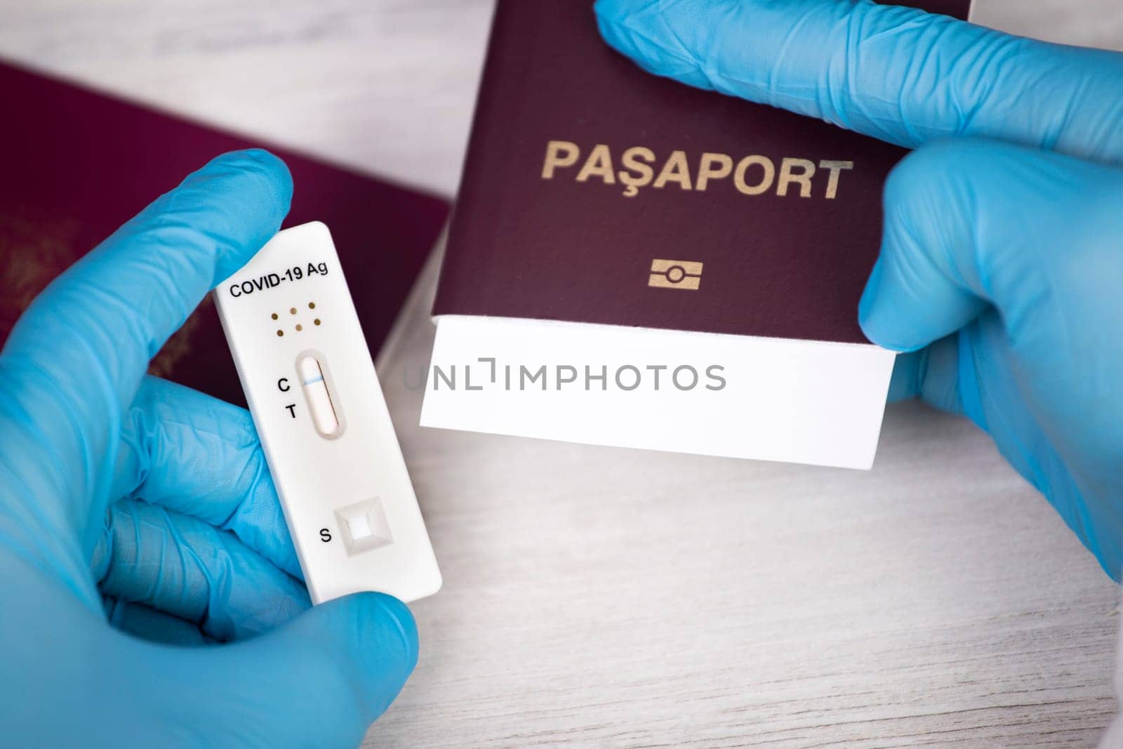 Doctor holding passport and negative covid-19 ( rapid antigen SARS-CoV-2 Ag ) test. Coronavirus and safety travel concept.