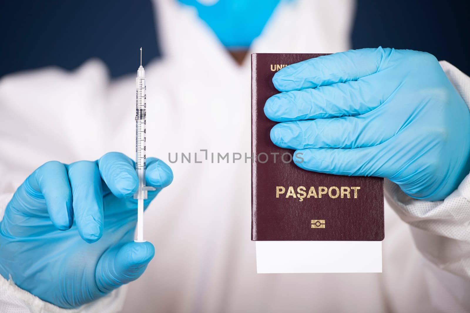 Doctor holding passport and vaccine. Immunity passport, risk-free certificate concept.